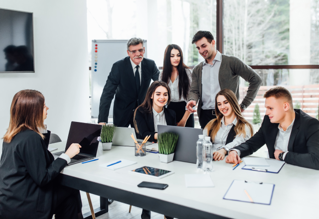 staff-meeting-group-young-modern-people-smart-casual-wear-discussing-something-while-working-creative-office-business-time 1