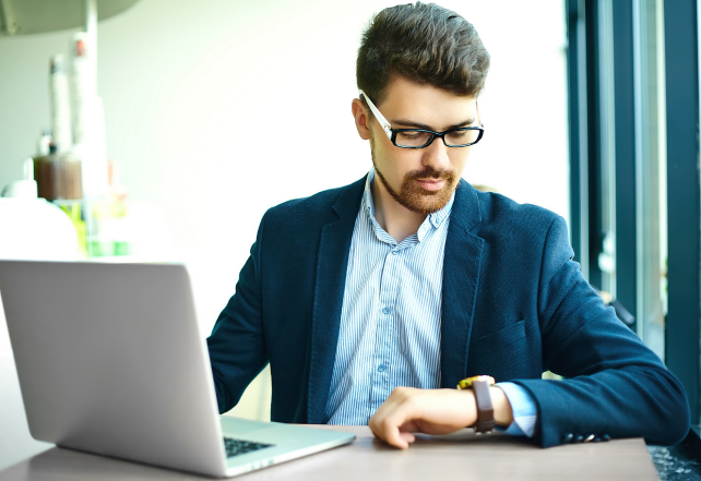 young-fashion-smiling-hipster-man-city-cafe-during-lunch-time-with-notebook-suit-looking-watches 1